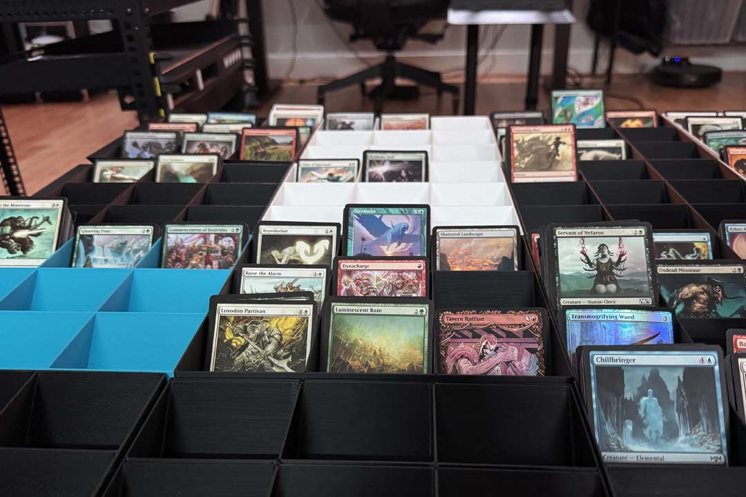 Card sorting setup with multiple sorting trays and organized cards